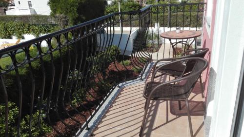 a balcony with a table and chairs and a fence at Solar de Mos in Lagos