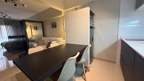 a kitchen with a black table and white chairs at Casco Histórico Apart I in Buenos Aires