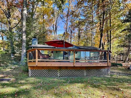 a large deck with an umbrella on top of it at Mountain Escape in McHenry