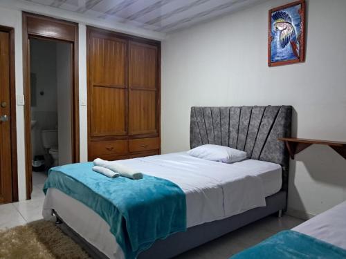 a bedroom with a bed with a towel on it at AMAZONIKA Casa de Huespedes in Puerto Inírida