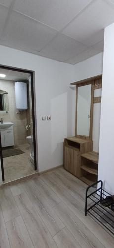 a room with a bathroom with a toilet and a mirror at Апартаменти Борови хълмове in Pamporovo