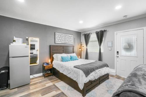 a bedroom with a large bed with blue pillows at Luxury Cozy Studio with Firepit in Vista