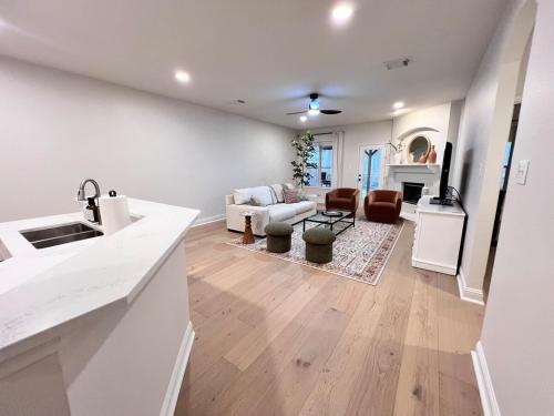 a kitchen and living room with white walls and wooden floors at Spacious Roanoke Retreat in Roanoke