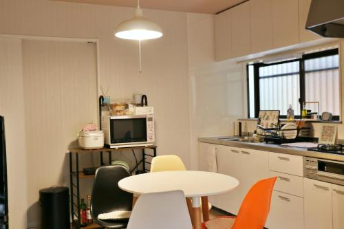 a kitchen with a table and a white table and chairs at Chichibunbun - Vacation STAY 19423 in Chichibu