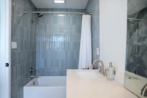a bathroom with a sink and a shower at Sea'scape - Heated Pool, Beach Gear, Pet Friendly, Beach Views in Pensacola Beach