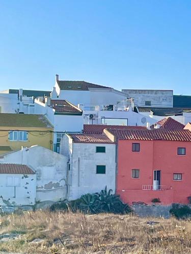 a group of buildings sitting on top of a field at PENICHE As Estrelas -Trois hébergements au choix accès indépendants même rue - proche centre -calme -confort -climatisés - plages -surf- Parking free in Peniche