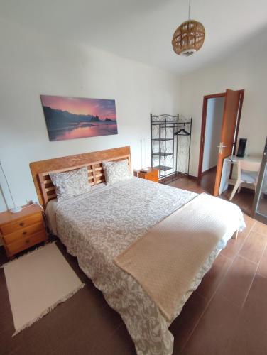 a bedroom with a large bed and a table at Casa Los Artesanos in Santa Cruz de Tenerife