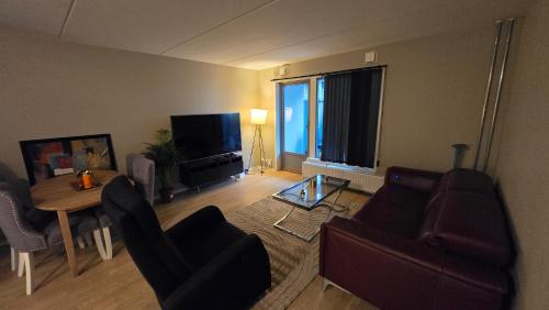 Телевизор и/или развлекательный центр в 2BR Cozy Oslo City Central Apartment