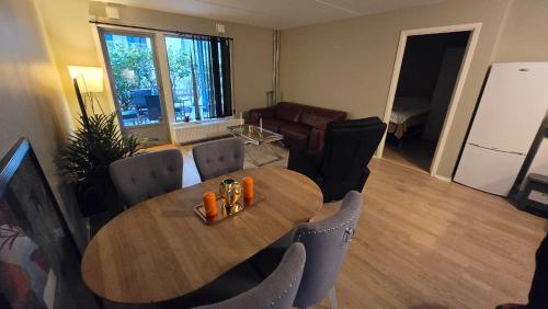 a living room with a wooden table and chairs at 2BR Luxury Apt in Ringnes Park Oslo City Center in Oslo