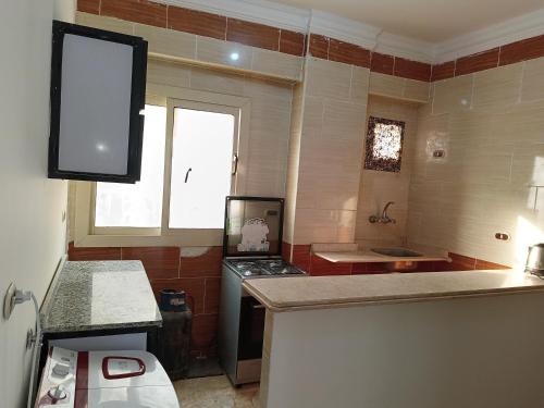 a kitchen with a stove and a counter top at Guest room science in Marsa Alam City