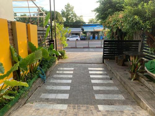 a brick walkway with plants on the side of a street at Ngoc Kha Tu 2 Hotel in Long Xuyên