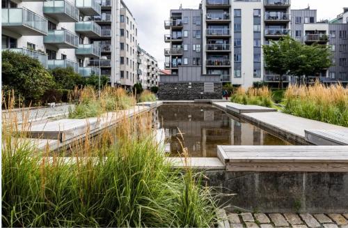 a pond in a city with tall buildings at 2BR Luxury Apt in Ringnes Park Oslo City Center in Oslo