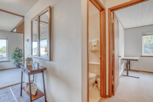 a bathroom with a toilet and a mirror at Sea Base in Lincoln City