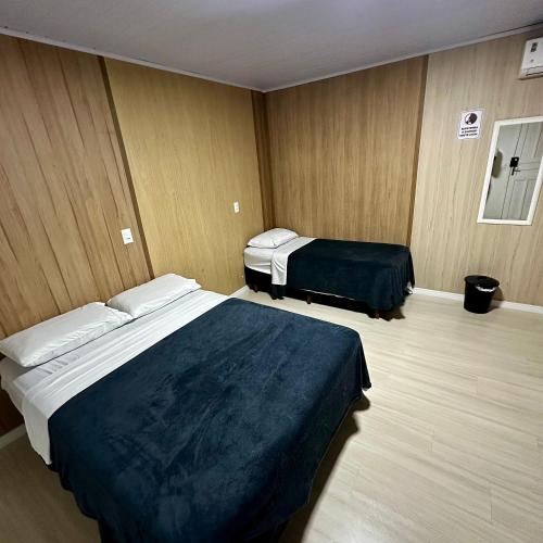 a hotel room with two beds in a room at Loft Lux 10 Centro in Chapecó
