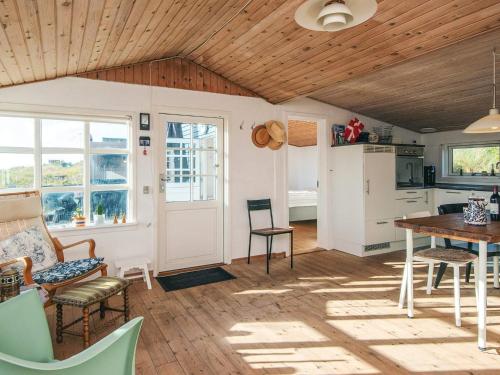 a kitchen and dining room with a wooden ceiling at 4 person holiday home in Grenaa in Grenå