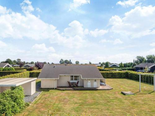 a small white house with a yard at 6 person holiday home in Haderslev-By Traum in Flovt