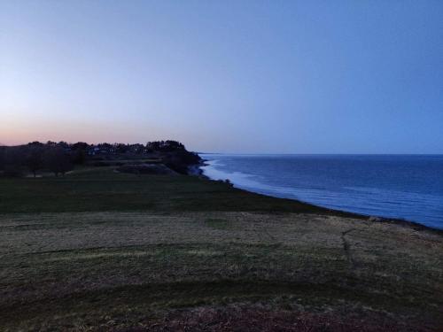 a view of the ocean from the shore at 5 person holiday home in Ebeltoft-By Traum in Øksenmølle