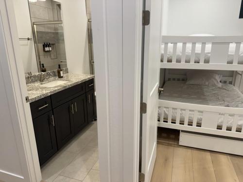 a bathroom with a sink and a bunk bed at Mountain Pines Getaway in Flagstaff