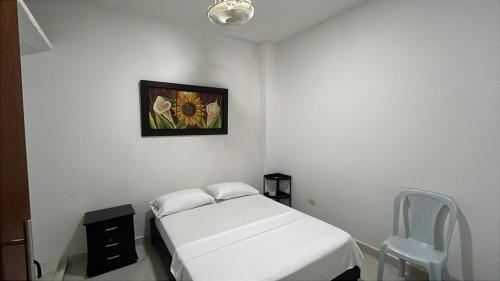 a hospital room with a bed and a painting on the wall at Sweet Dreams Necocli in Necoclí