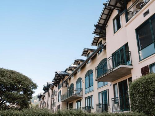a row of apartment buildings with balconies at Hotel St Moritz, Queenstown - MGallery Collection in Queenstown