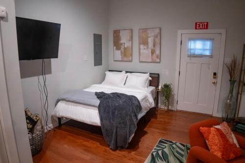 a bedroom with a bed and a flat screen tv at Centrally-Located Studio in DWTN Richmond in Richmond