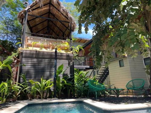 a swimming pool in front of a house at Mar Botánico - Avellanas Beach Hotel in Playa Avellana