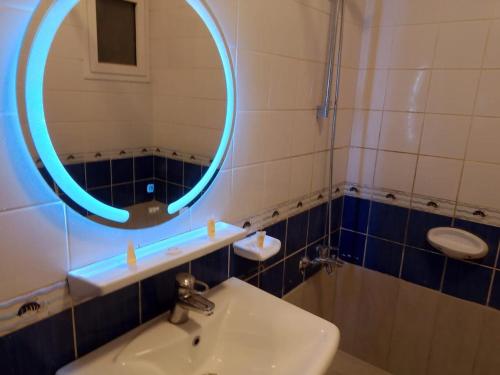 a bathroom with a sink and a mirror at ميراكي ريزورت , meraki resorts , durrat alarous , درة العروس in Durat  Alarous