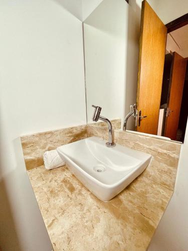 a bathroom counter with a sink and a mirror at Pousada Solana in Salvador