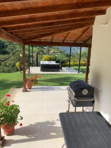 a barbecue grill sitting on a patio under a pergola at La Miel in Barbosa