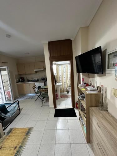 a living room with a flat screen tv on the wall at Studio Castra in Thessaloniki
