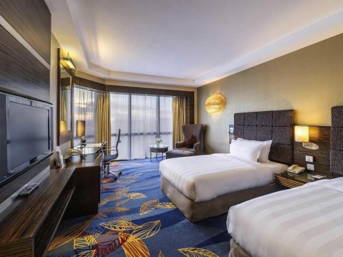 Cama o camas de una habitación en Novotel Beijing Peace