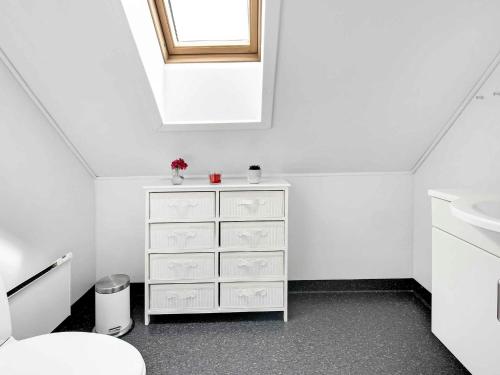 a bathroom with a white dresser and a sink at 5 star holiday home in Brenderup Fyn in Åbjerg