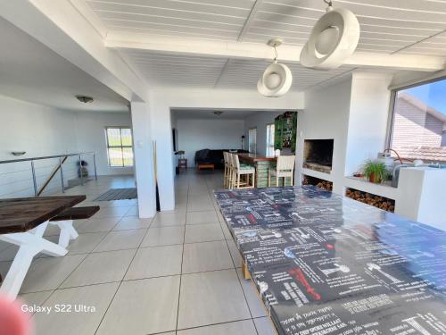 a living room with a table and a dining room at 87 on Sunbird in Langebaan