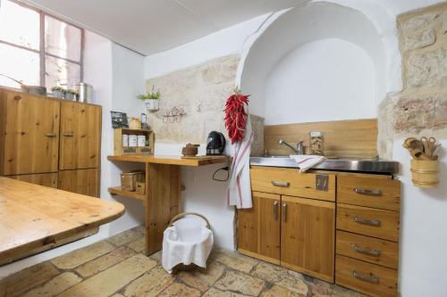 a kitchen with wooden cabinets and a sink at Helni Ha Malka Apartment By A b c in Jerusalem