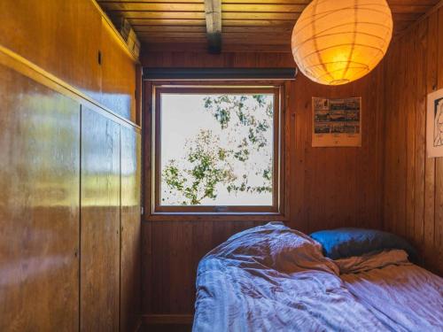 a room with a bed and a window and a lamp at 5 star holiday home in Gørlev in Ornum