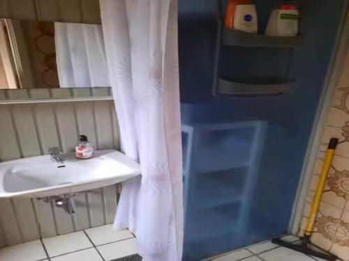 a bathroom with a sink and a white shower curtain at 5 star holiday home in Ørsted in Udbyhøj