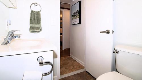 a bathroom with a white toilet and a sink at Summer Breeze in Cape May Point