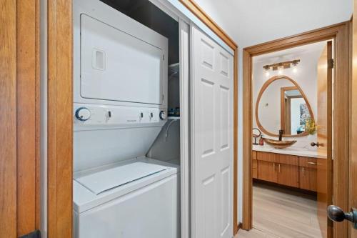 a white refrigerator in a kitchen with a mirror at Kapalua Ridge Villas 1023 in Kahana