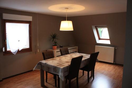 a dining room with a table and chairs at Gite Le coeur des Ribeaupierres in Ribeauvillé