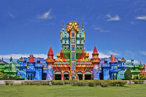a disney castle building with a colorful at Ap 440 m do mar, próx Beto Carrero in Navegantes