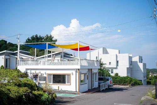a house with two flags on top of it at Yiriro Stay in Kwangnyŏng-ni