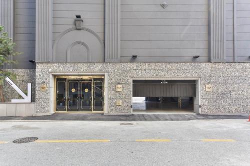 a building with a entrance with a parking garage at Wonju Hotel Raum in Wonju