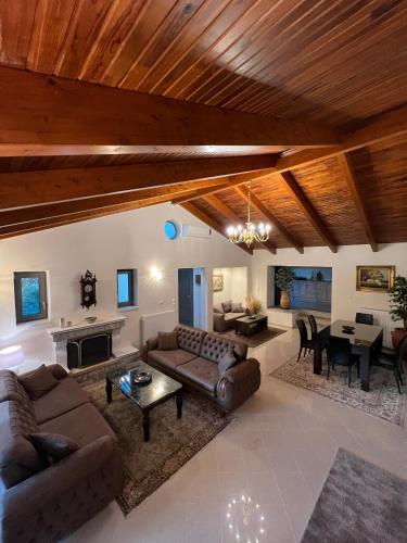 a living room with couches and a dining room at Entire Apartment 140m2 near Syvota and Parga in Makrochóra