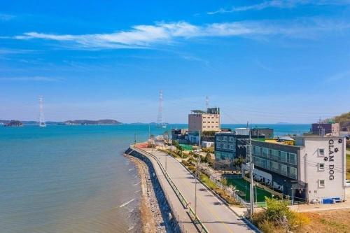 a view of a city with the ocean and buildings at Glamdog Dog Pension Yeongheungdo Branch in Pŏdŏni