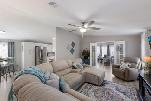 a living room with a large couch and a kitchen at The Salty Sister Retreat in Englewood