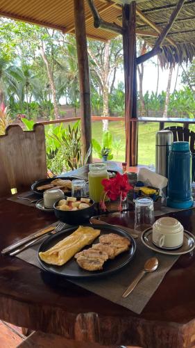 a table with plates of food on top of it at Playa Ganadito Ecolodge in Drake