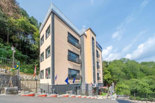 un edificio alto con banderas delante en Gapyeong The Cozy Pool Villa, en Piryŏngtŏ-ri