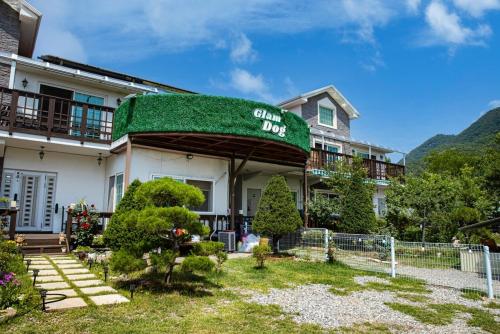 a building with a green awning on it at Glamdog Dog Pension Gapyeong Branch in Gapyeong