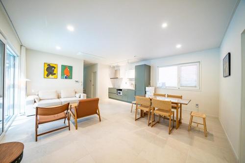 a living room with a couch and a table at Yangyang Sonamu Private Pension in Yangyang