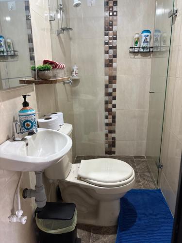 a bathroom with a toilet and a sink and a shower at Hogar De Ensueño in Envigado